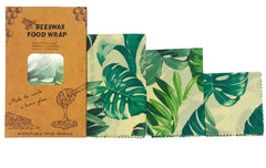 Beeswax food wrap with leaf patterns and packaging on a white background