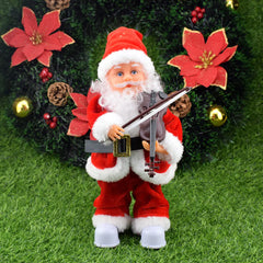 Santa Claus figurine playing a violin with Christmas decorations in the background