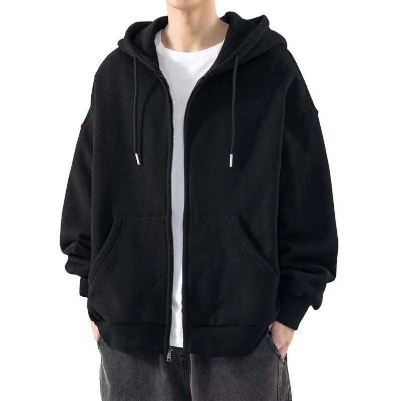 Person wearing a black hoodie over a white shirt on a white background