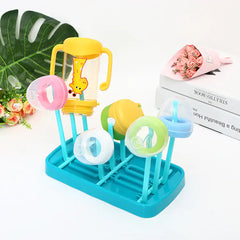 Blue baby dish drying rack on a white background showing bottles and lids drying on it