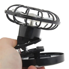 Black portable fan with transparent cage on a white background has clip to mount