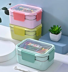 Stackable lunch boxes in pink, yellow, and green with stainless steel interior and clear plastic lid