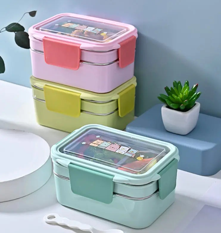 Stackable lunch boxes in pink, yellow, and green with stainless steel interior and clear plastic lid