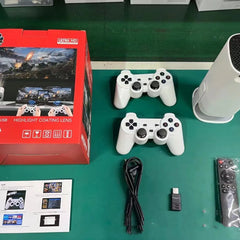 Gaming controllers, box, and accessories on a green surface