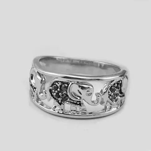 Silver ring with elephant design on a light gray background