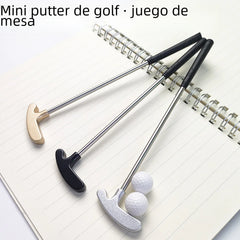 Mini golf putters and balls on a notebook with text 'Mini putter de golf · juego de mesa'.