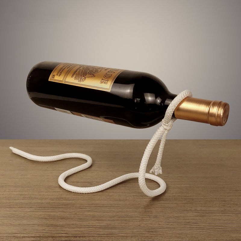Wine bottle tied with a rope that looks like suspended in mid air, but the rope is actually a wrought iron stand balanced to hold the bottle.