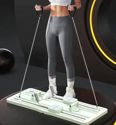 Person using a portable belly panel, standing on it and holding the handles in an underhanded grip