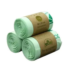 Three rolls of green biodegradable pet waste bags with brown labels on a white background